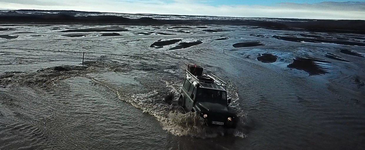 Amanda Stockton steering Landcruiser through flooded entrance to field site (Credit Mike Toillion)