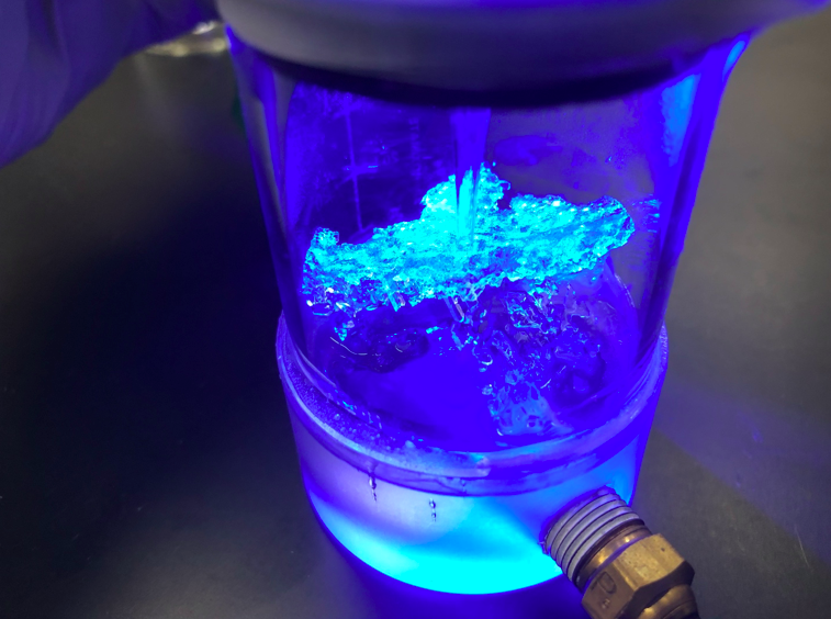 A clathrate that is stable at atmospheric pressure, grown at the end of a pipette in the presence of a clathrate-binding protein (CBP). The clathrate surface glows, indicating that the CBP is indeed binding to the clathrate.