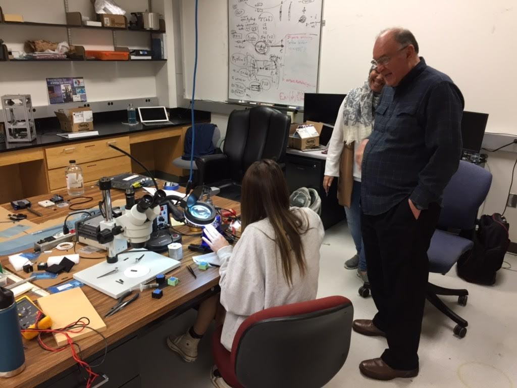 Eskew (seated) building muon telescopes in lab