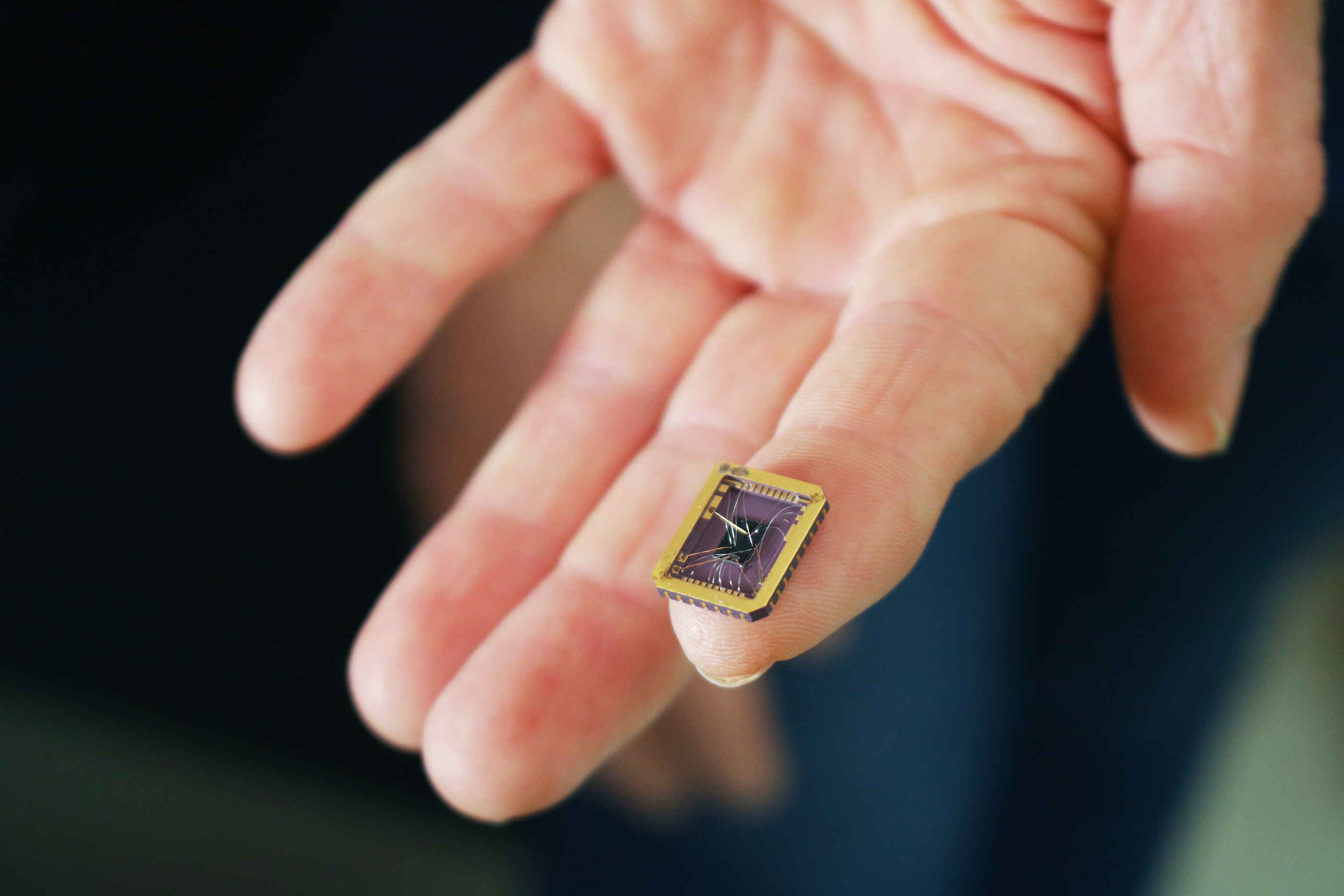 Claire Berger holds a graphene device grown on a silicon carbide substrate chip. Credit: Jess Hunt-Ralston