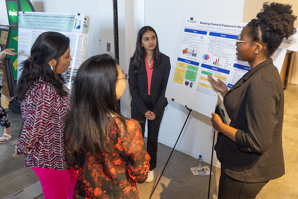 Students present their poster on chemical equity