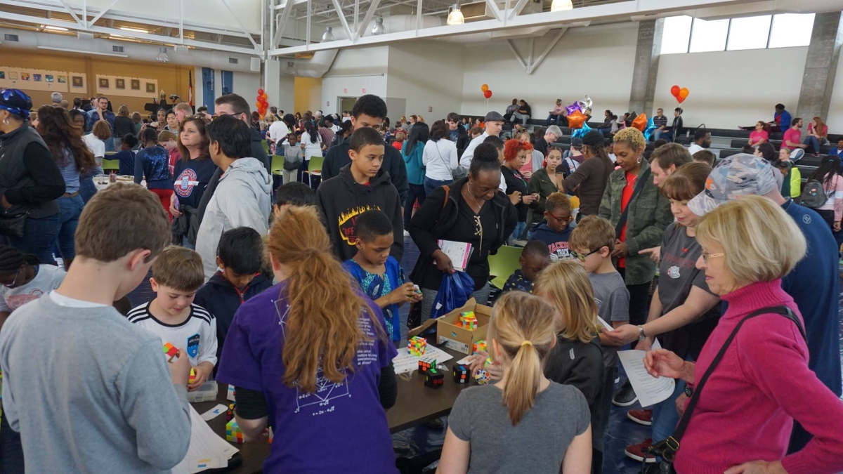 A large crowd can be seen at a past Mathapalooza! event. 