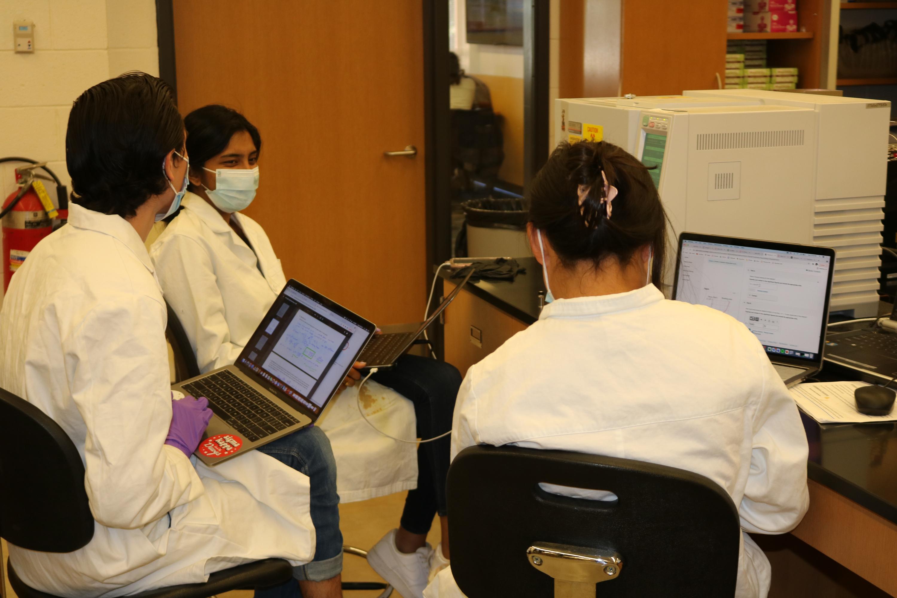 Jack Winn (left), Dhruti Triveti, and Julianna Mercado wait for measurements from specialized equipment in the Analytical Chemistry Lab in the Boggs Building. (Photo Renay San Miguel)