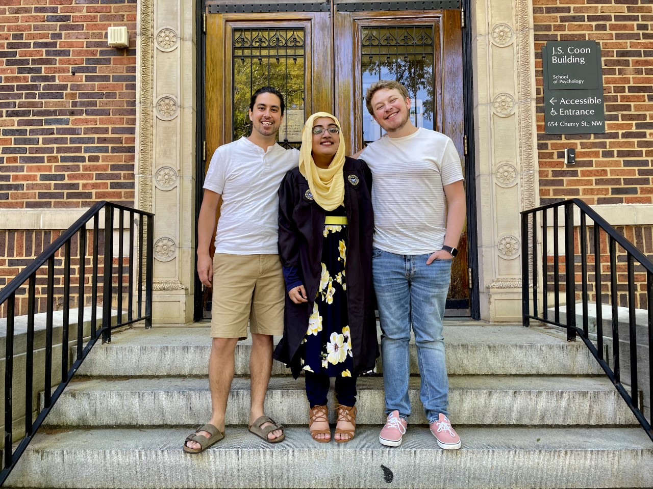 Zulfiqar, center, celebrating graduation with two mentors, who are current graduate students. 