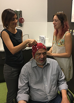 Audrey Duarte and Brittany Corbett adjust memory test sensors on ScienceMatters host Renay San Miguel