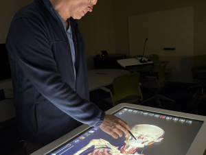 Adam Decker demonstrates how the Anatomage Table turns traditional dissection into a high-tech learning experience.
